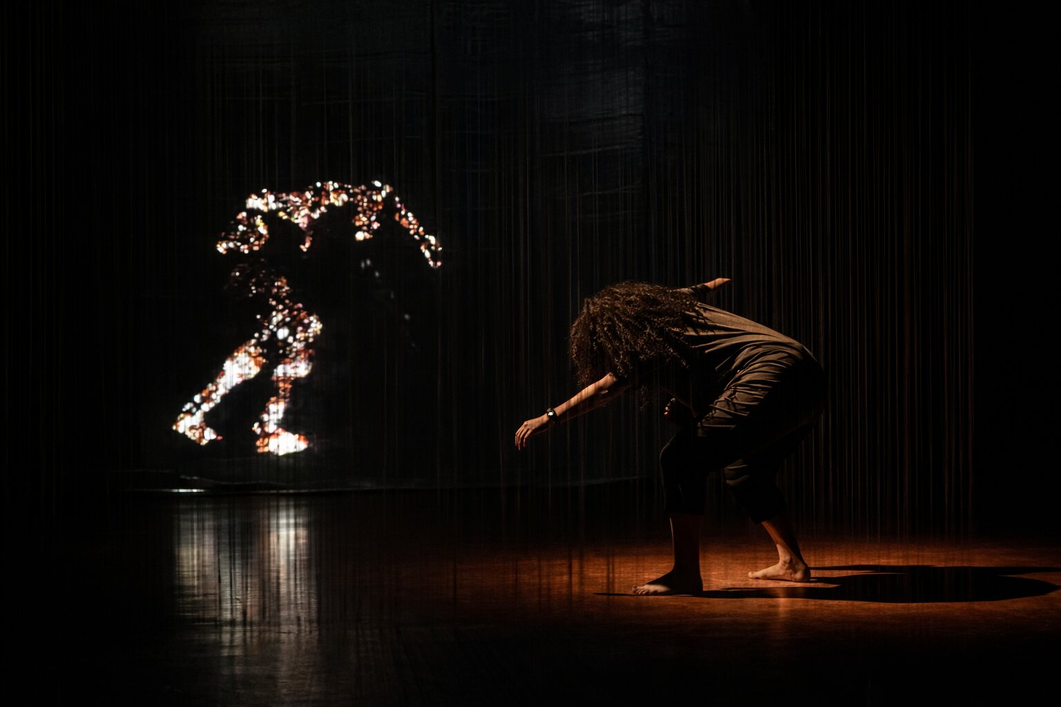 Margaret J Harvey performing with a projected digital double